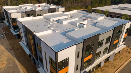 commercial building with flat white roof