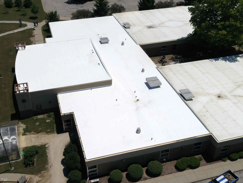 Aerial view of a educational facility with a coated roof